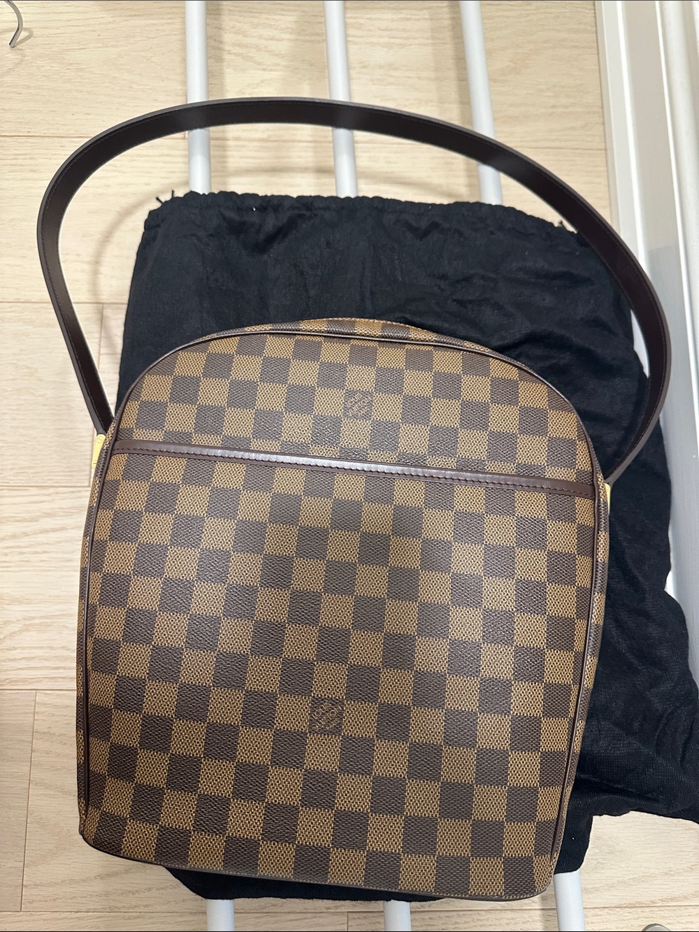 Louis Vuitton Bag crafted from elegant Damier Ebene canvas with cowhide trim.